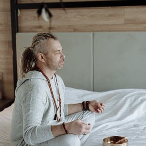 Person sitting in quiet meditation after practice.